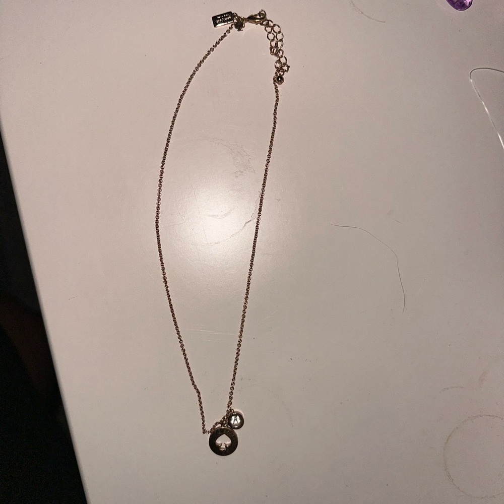 Kate spade necklace. With Kate spade logo and stone accent.